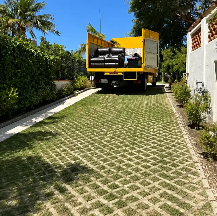 After: the same driveway cleared and swept clean by Crisan Junk Removal, with the junk loaded and hauled away